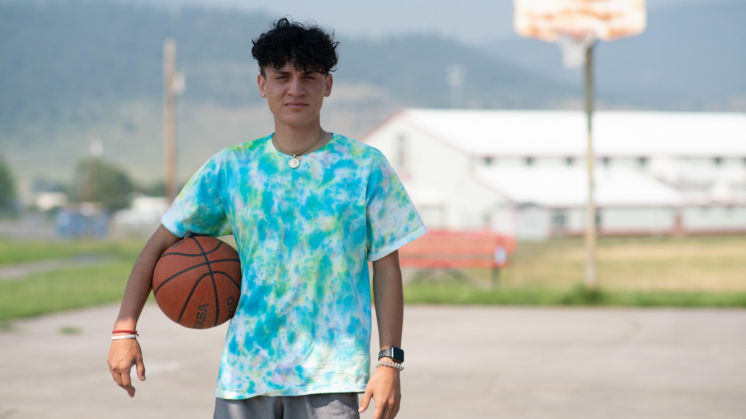 Mental health and suicide prevention advocate Greg Whitesell holds a basketball.