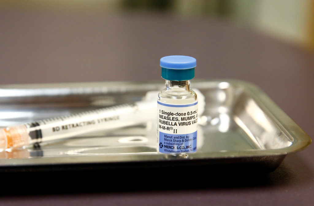 A vial of the measles, mumps, and rubella (MMR) vaccine is pictured at the International Community Health Services clinic ...