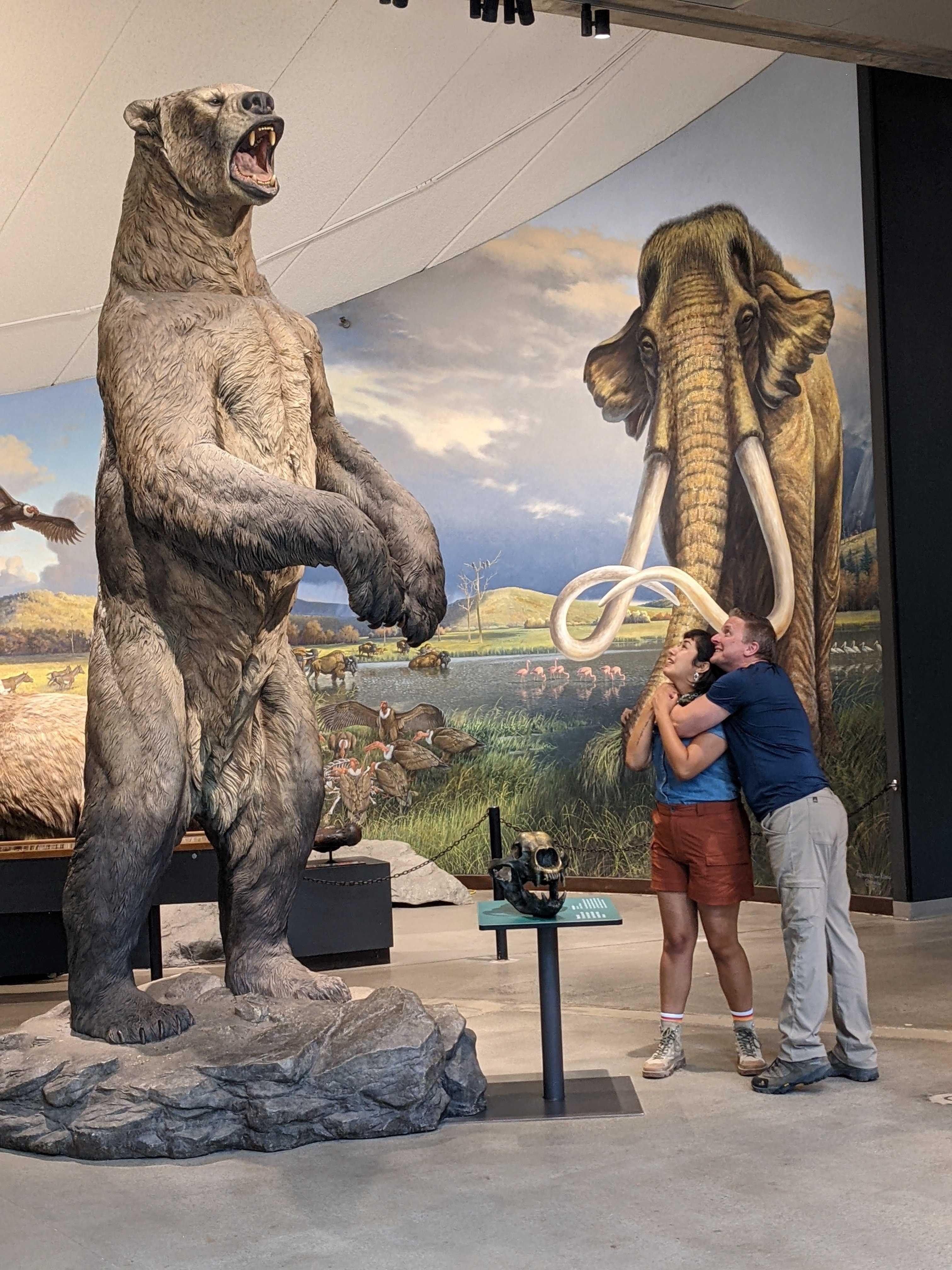 Michelle Barboza-Ramirez and Blake de Pastino examining a bear statue on-location at the La Brea Tar Pits.