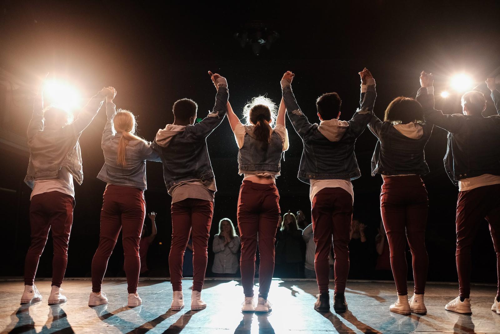 Row of performers taking a bow