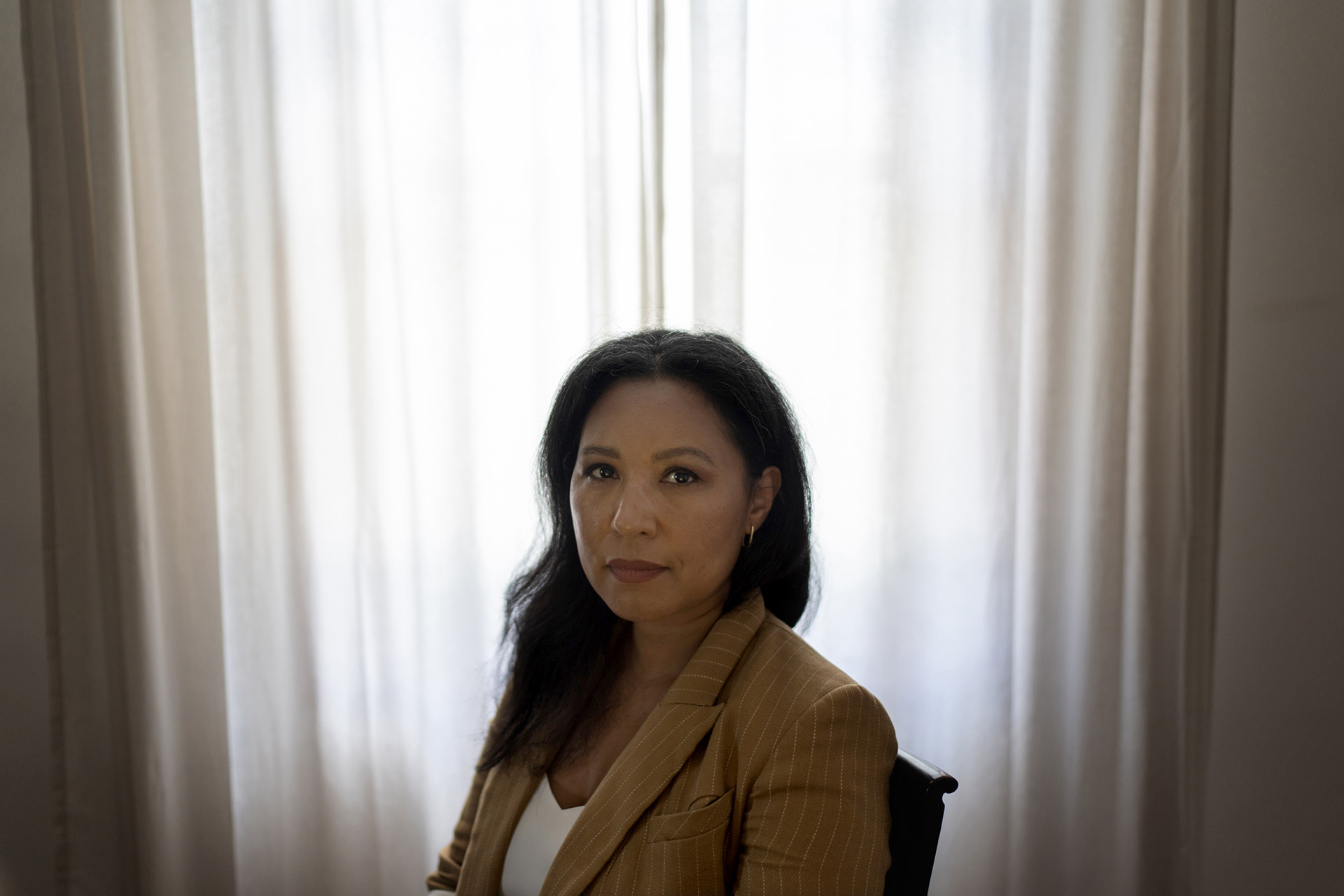 Maria Leister sits and poses for a portrait at her home.